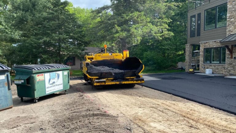 Davis Construction Company image of them laying asphalt that links to a video