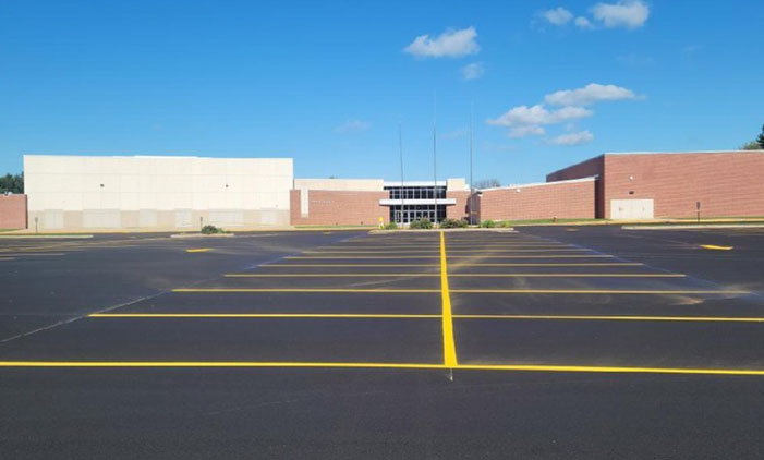Line-work-in-parking-lot New parking lot at a high school done by Davis construction with new parking space lines