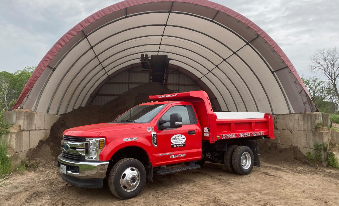 New-Truck-in-front-of-top-soil New truck in-front of pile pf topsoil available for sale